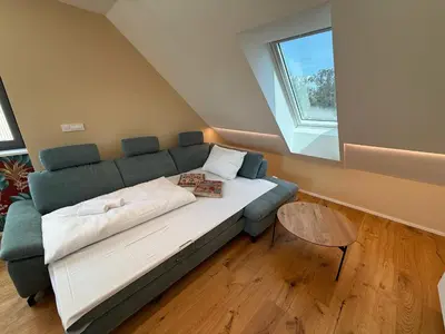 a living room with a couch and a window at Crown Residence Luxury 2BR in Ljubljana Downtown in Ljubljana