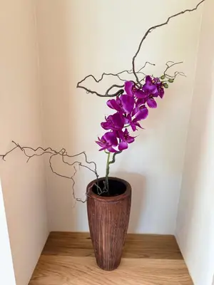 a vase filled with purple flowers on a table at Crown Residence Luxury 2BR in Ljubljana Downtown in Ljubljana