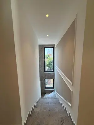 a hallway with white walls and a window at Crown Residence Luxury 2BR in Ljubljana Downtown in Ljubljana