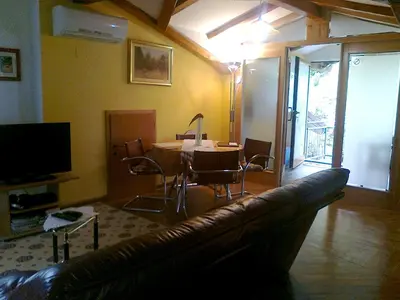 a living room with a couch and a table at Apartma 