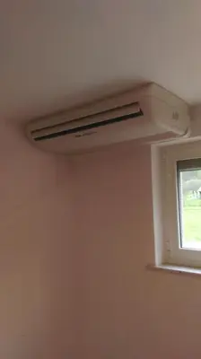 a ceiling fan in a room with a window at Apartma 