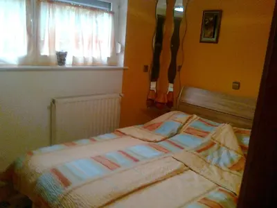 a bed sitting in a bedroom with a window at Apartma 