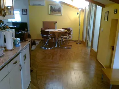 a kitchen with a table and chairs in a room at Apartma 