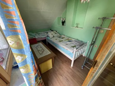 a small room with a small bed in it at Cvetlični Vrt in Radovljica
