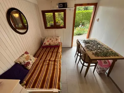 a room with a bench and a table and a table at Cvetlični Vrt in Radovljica