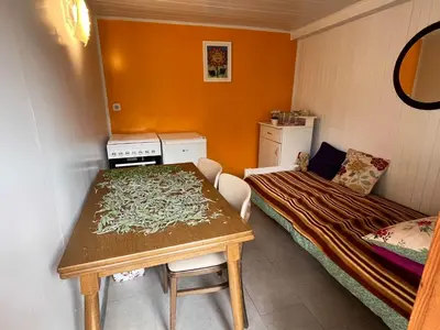 a small room with a table and a bed at Cvetlični Vrt in Radovljica