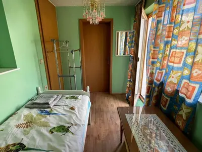 a bedroom with a bed and a table in it at Cvetlični Vrt in Radovljica