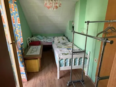 a small room with a bunk bed and a table at Cvetlični Vrt in Radovljica