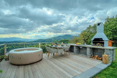 a deck with a hot tub and a grill at Holiday home in Trebelno - Dolenjska & Bela krajina (Unter- & Weißkrain) 54728 in Trebelno