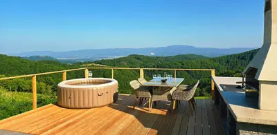 a deck with a hot tub and a table and chairs at Holiday home in Trebelno - Dolenjska & Bela krajina (Unter- & Weißkrain) 54728 in Trebelno