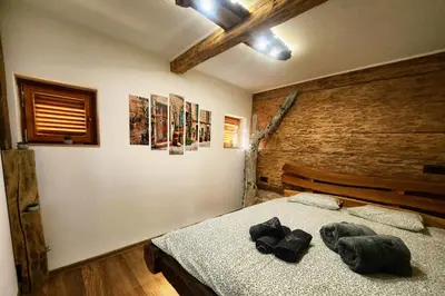a bedroom with a bed with two black towels on it at Holiday home in Trebelno - Dolenjska & Bela krajina (Unter- & Weißkrain) 54728 in Trebelno