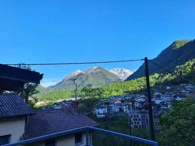 a view of a city with mountains in the background at Hiša Gadiča in Tolmin