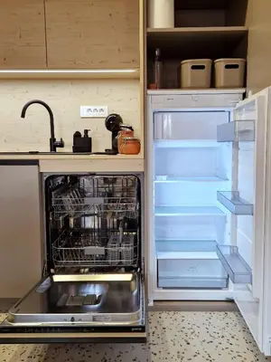 an empty refrigerator with its door open in a kitchen at House B in Dekani