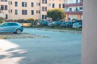 a car parked in a parking lot next to a building at Maribella Apartment II in Maribor
