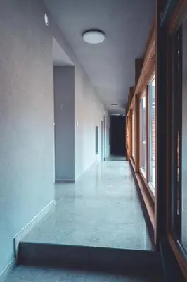 an empty hallway of an empty building with windows at Maribella Apartment II in Maribor