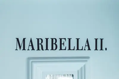 a sign that reads marbella above a white door at Maribella Apartment II in Maribor