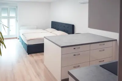 a bedroom with a dresser and a bed in it at Maribella Apartment II in Maribor