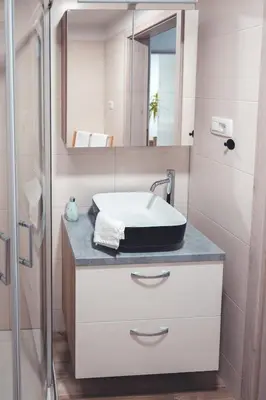 a bathroom with a sink and a mirror at Maribella Apartment II in Maribor