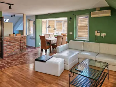 a living room with a white couch and a table at Apartmaji Remsova in Maribor