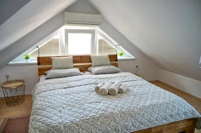 a bedroom with a bed with two towels on it at Apartmaji Remsova in Maribor