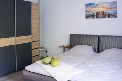 a bedroom with a bed with a pillow on it at Apartma LONČAR in Horjul