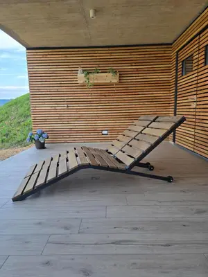 a wooden bench sitting on top of a patio at Parzival relax Apartment in Žetale