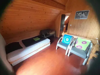 an overhead view of a bedroom with a bed and two chairs at Owl's Nest Bovec in Bovec