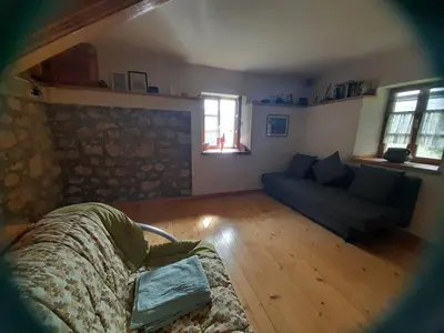 a living room with a bed and a couch at Owl's Nest Bovec in Bovec