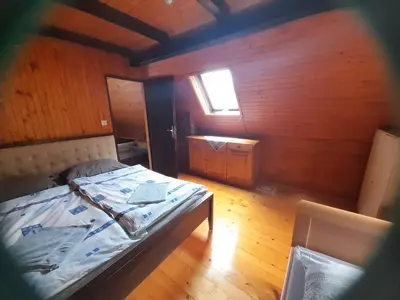 a bedroom with a bed in a wooden room at Owl's Nest Bovec in Bovec