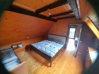 an overhead view of a bedroom with a bed in a cabin at Owl's Nest Bovec in Bovec