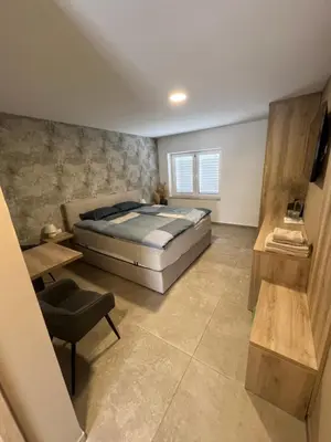 a bedroom with a bed and a table and a chair at Korantov Hram