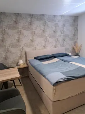 a bedroom with a large bed with blue pillows at Korantov Hram