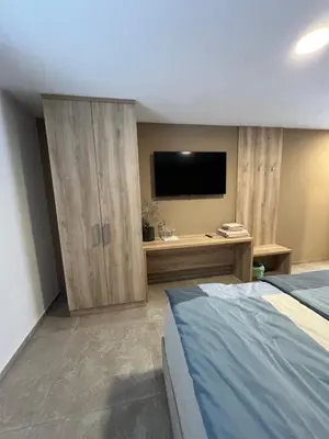 a bedroom with a bed and a flat screen tv at Korantov Hram