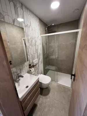 a bathroom with a shower and a toilet and a sink at Korantov Hram