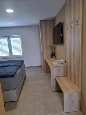 a bedroom with a bed and a desk in a room at Korantov Hram