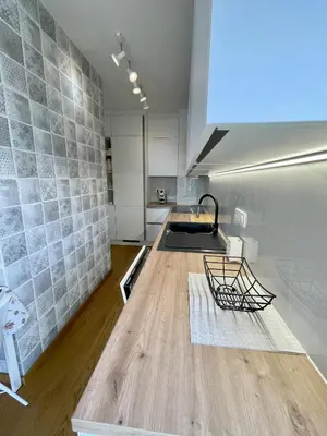 a kitchen with a wooden counter top in a room at Apartment LEON in Ljubljana