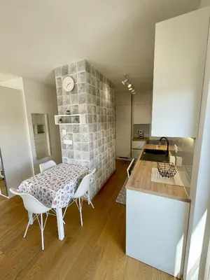 a kitchen and dining room with a table and chairs at Apartment LEON in Ljubljana