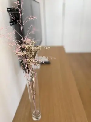 a vase with flowers in it sitting on a table at Apartment LEON in Ljubljana