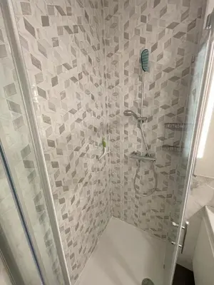 a bathroom with a shower with a glass door at Apartment LEON in Ljubljana
