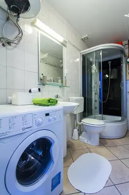 a bathroom with a washing machine and a toilet at Apartment Bright & Light in Ljubljana
