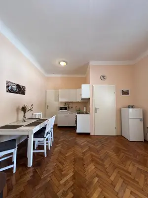 a kitchen and dining room with a table and chairs at Apartment Bright & Light in Ljubljana