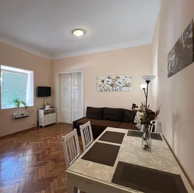 a living room with a table and a couch at Apartment Bright & Light in Ljubljana