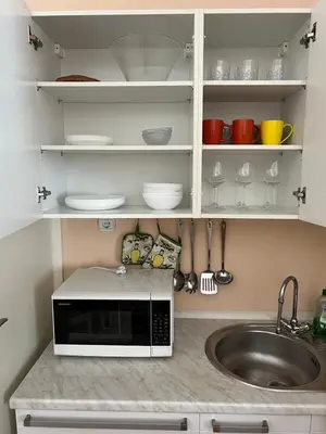 a kitchen with a sink and a microwave at Apartment Bright & Light in Ljubljana
