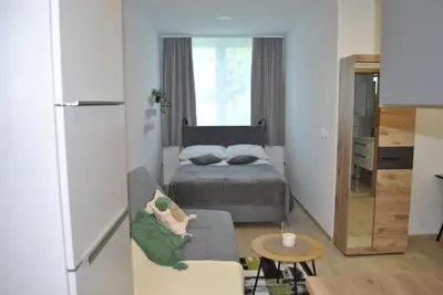 a small bedroom with a bed and a couch at Prenočišča Dany APARTMA 1 in Dravograd