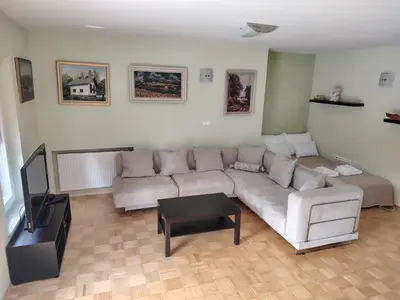 a living room with a couch and a tv at Apartment Green Oasis in Bled