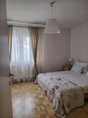 a bedroom with a bed and a large window at Apartment Green Oasis in Bled