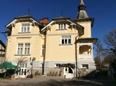 a large building with a tower on top of it at Guest House Veronika in Kočevje
