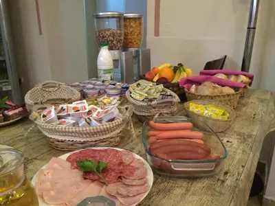 a table with baskets of food and fruits and vegetables at Guest House Veronika in Kočevje