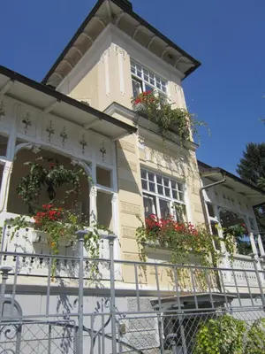 a building with flower boxes on the front of it at Guest House Veronika in Kočevje