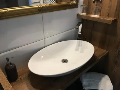 a white sink in a bathroom with a mirror at Guest House Veronika in Kočevje